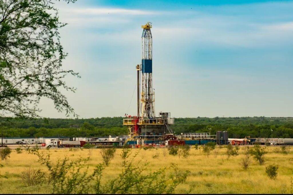 Land drilling rig on open field under blue sky, oilfield operations for drilling fluid additives procurement.